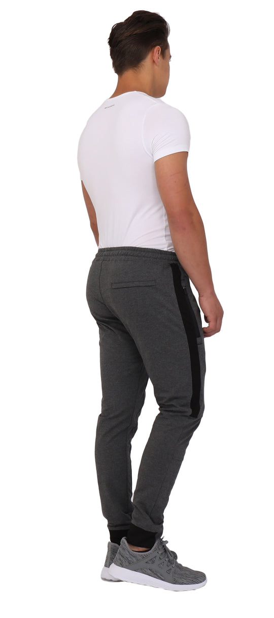 Dark grey/black joggers from the back with elastic waistband and side stripe