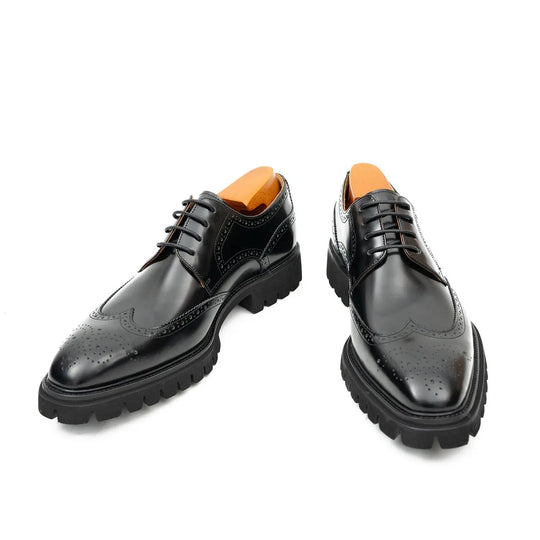 Pair of black derby brogue shoes with polished finish, lace-up closure, rugged sole