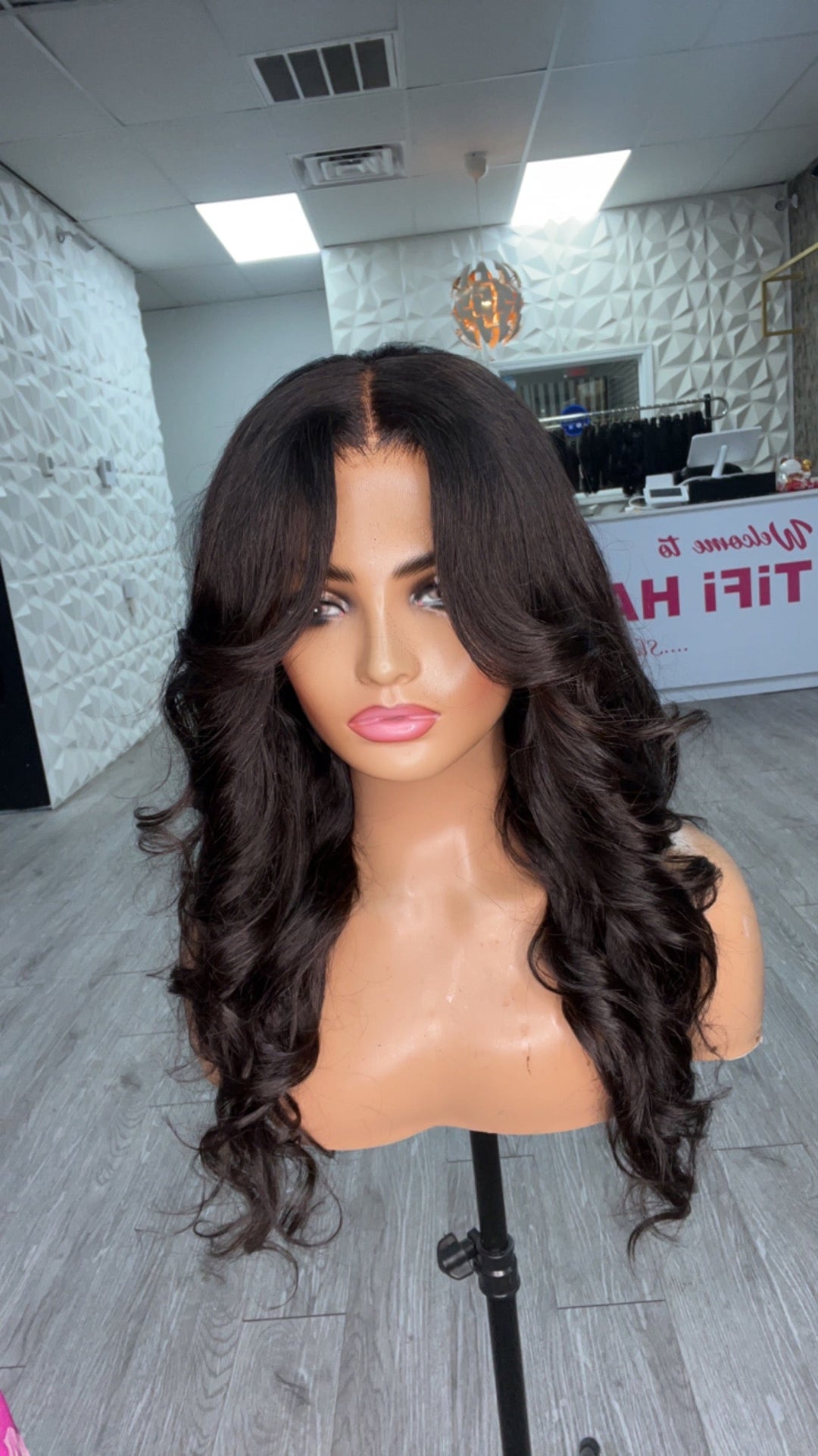 Cutie Unit close view: long black wavy hair with center part and soft curls
