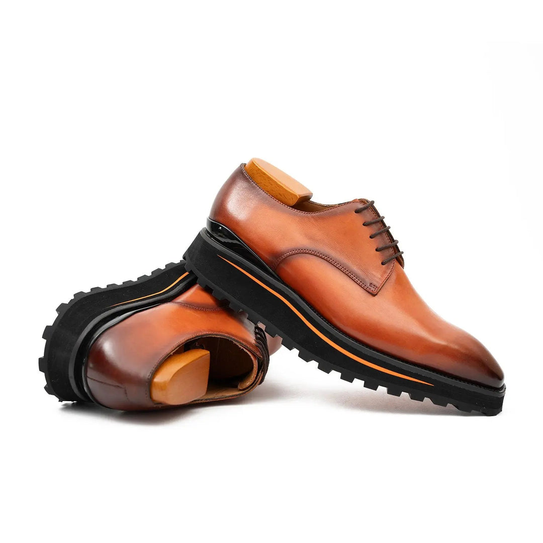 Brown lace-up derby shoes, side view with rugged tread outsole and orange trim stripe