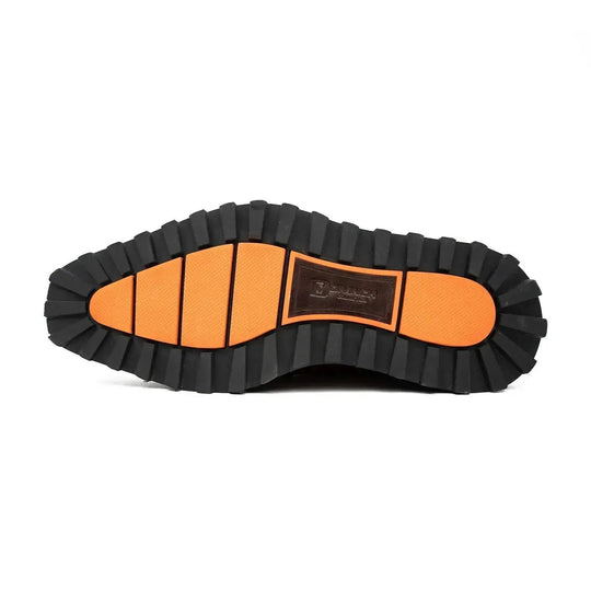 Brown derby shoes outsole tread, textured black rubber bottom with orange accent