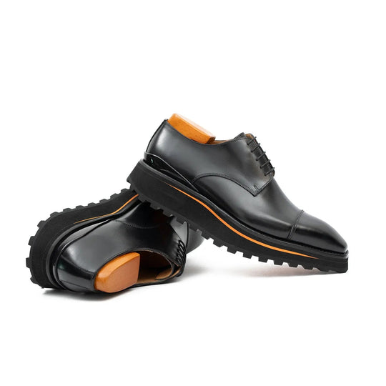 Pair view: black derby lace-up shoes with thick tread sole and orange edge stripe