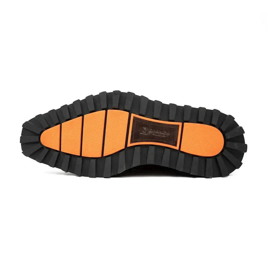 Outsole of black derby shoes with deep tread and orange-lined rubber segments