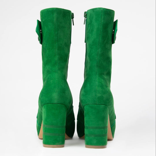 Pair of green suede boots back view with stacked block heels and side tabs