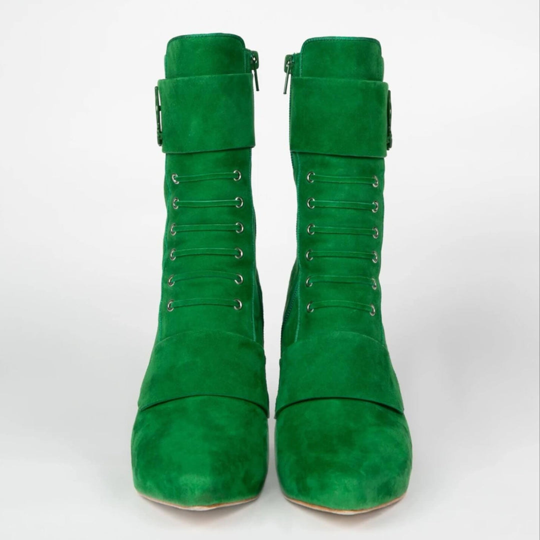 Pair of green suede boots front view with lace-up eyelets and side zipper