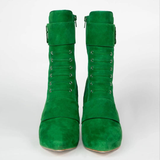 Pair of green suede boots front view with lace-up eyelets and side zipper