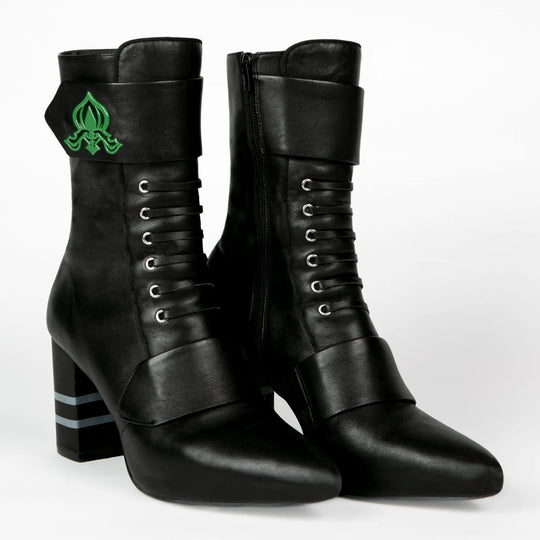 Black ankle boots with lace-up front and green logo on side