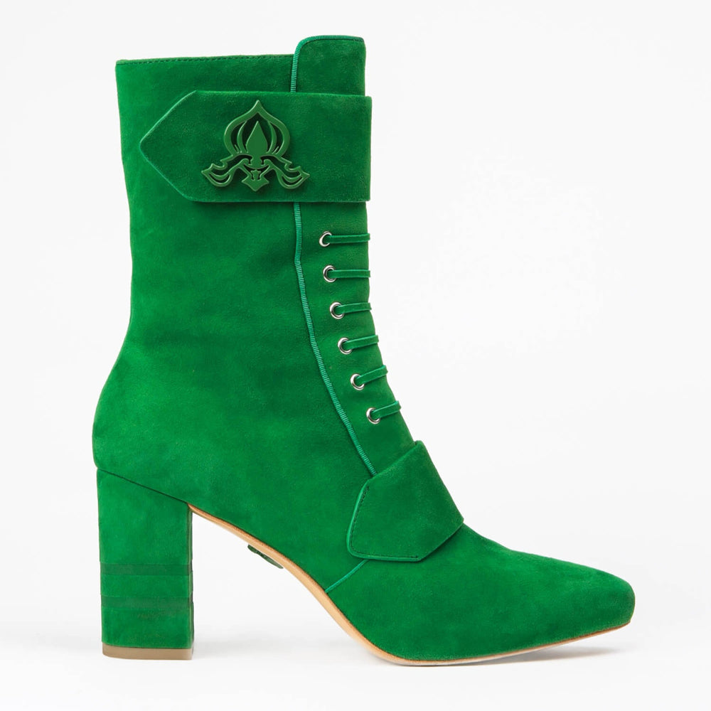 Green suede ankle boot with emblem strap detail, lace-up eyelets, and block heel