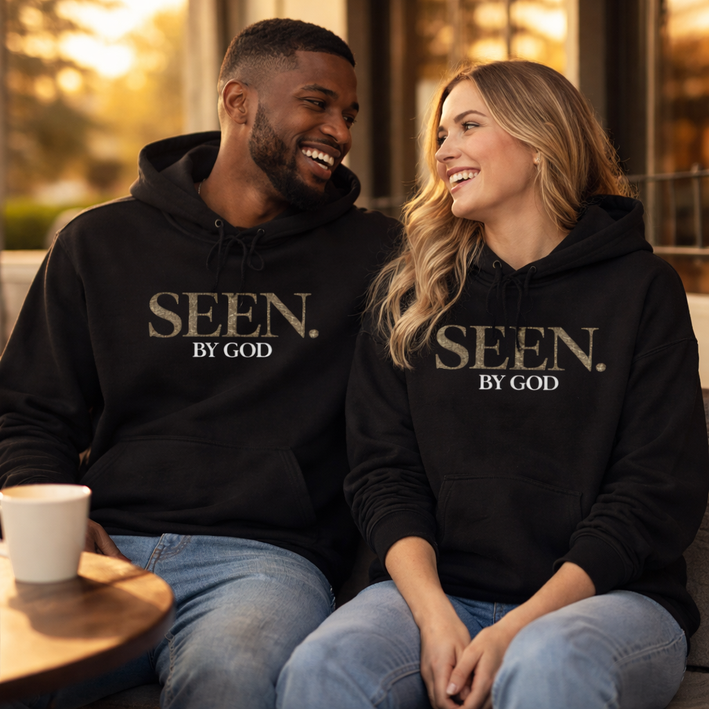 Black SEEN. by God hoodie on couple seated, showing front logo and pocket