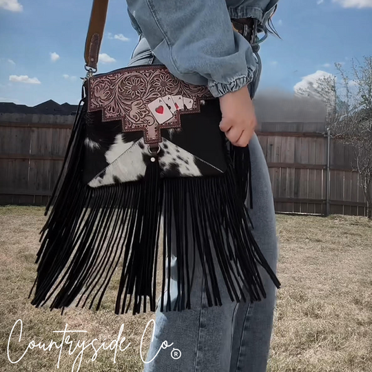 Cowhide fringe purse with dark leather top, floral tooling, black-and-white fringe