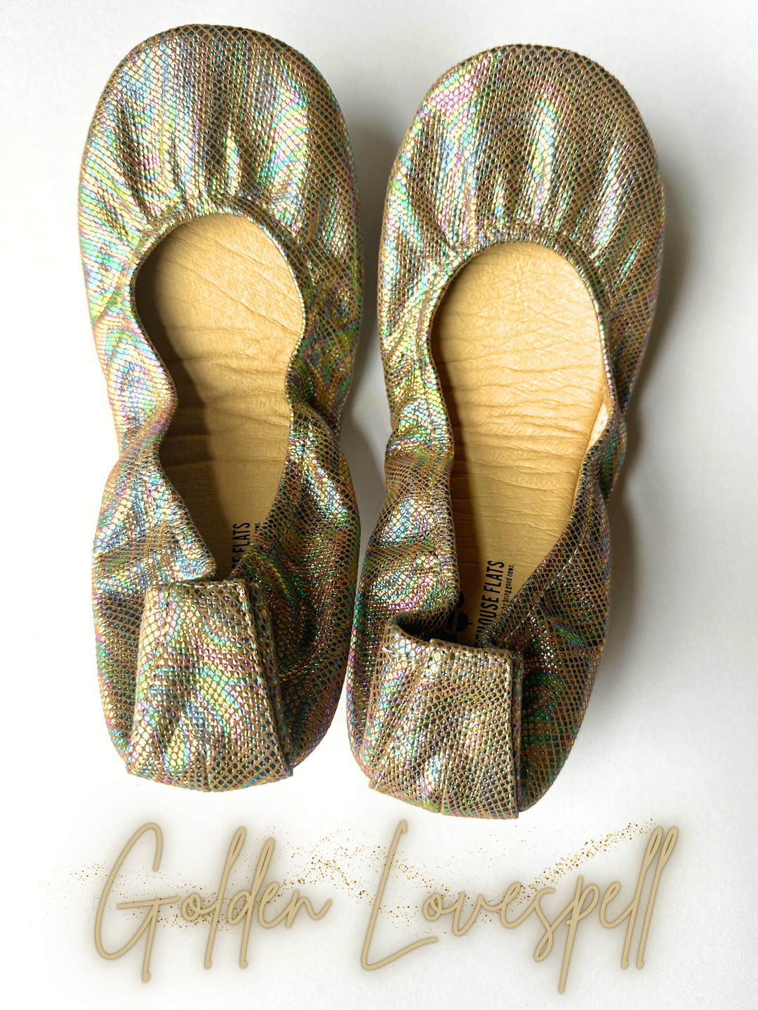 Pair of metallic iridescent flats with padded insoles and bow ties at the vamp