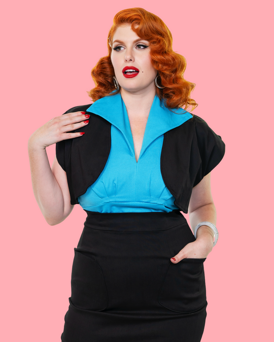 Front view of black pencil skirt and turquoise top with open black bolero