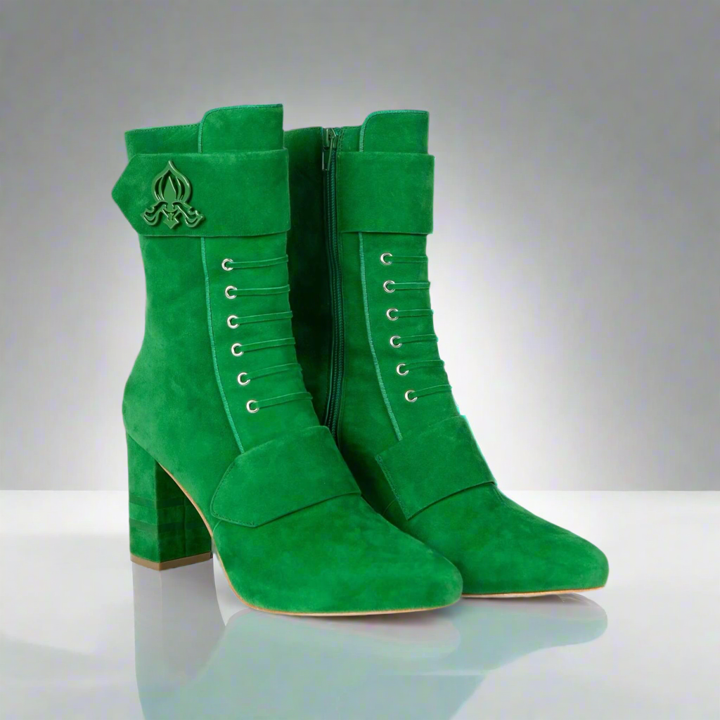 Green suede ankle boots with side zipper and lace-up eyelets, emblem on cuff