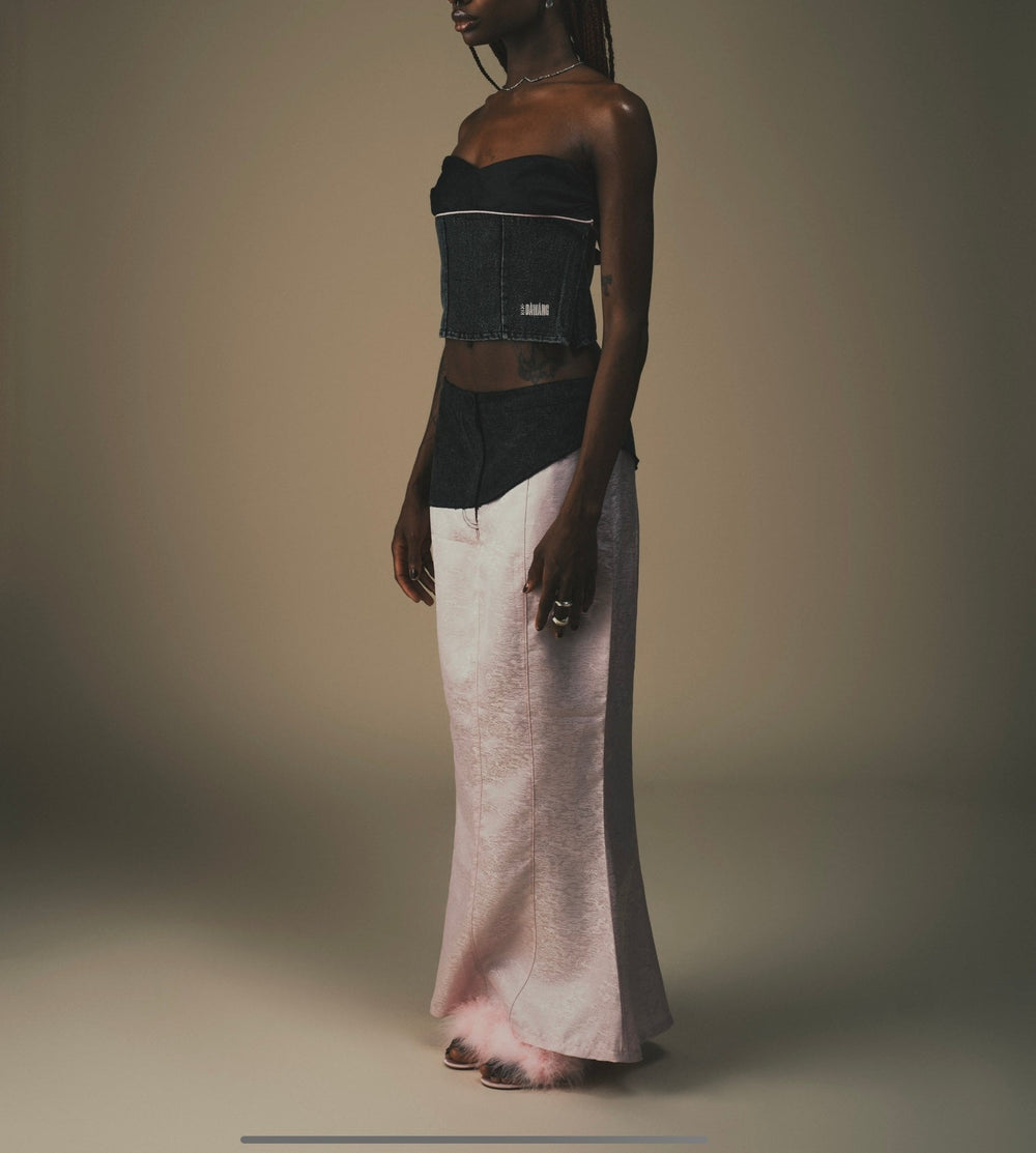Fei Patch Maxi Skirt side view: light pink hem with dark waistband patch detail.