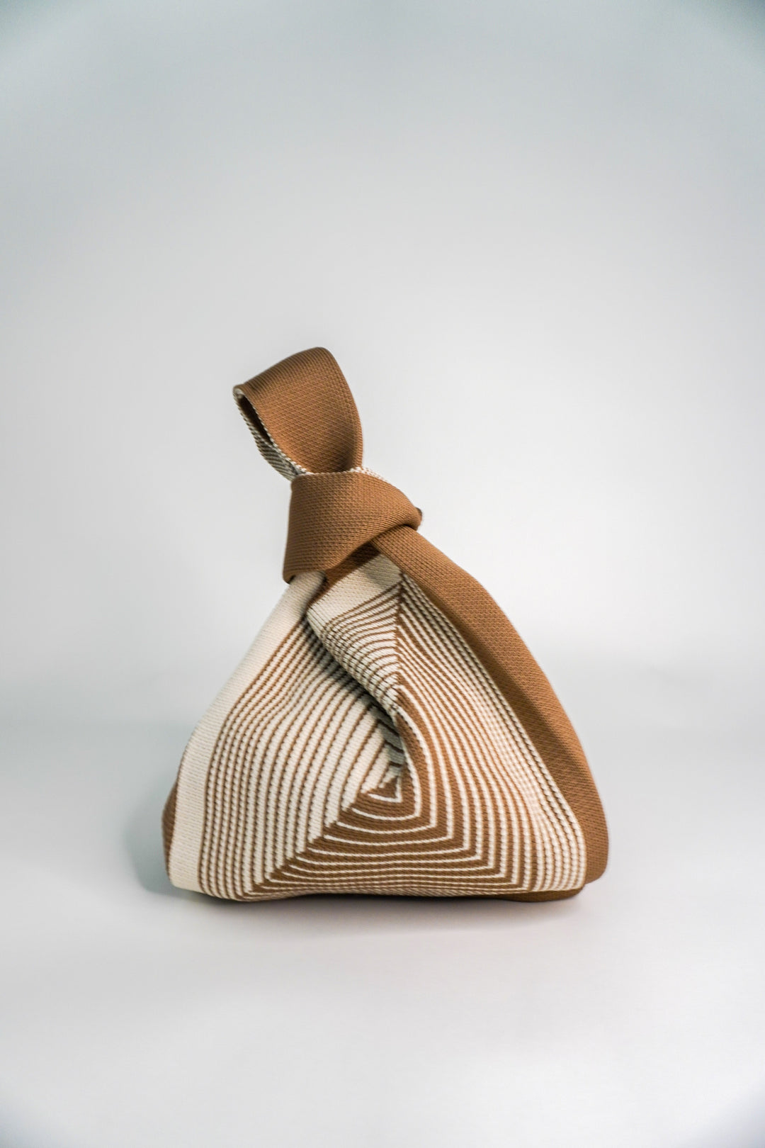 Beige handbag, knotted top handle, geometric labyrinth pattern