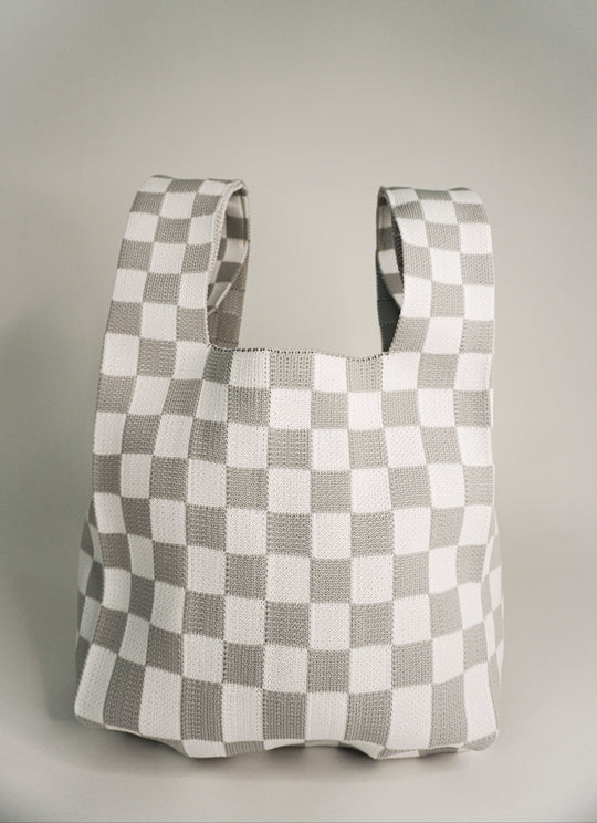 Checkered tote-style handbag with wide strap openings, grey and white