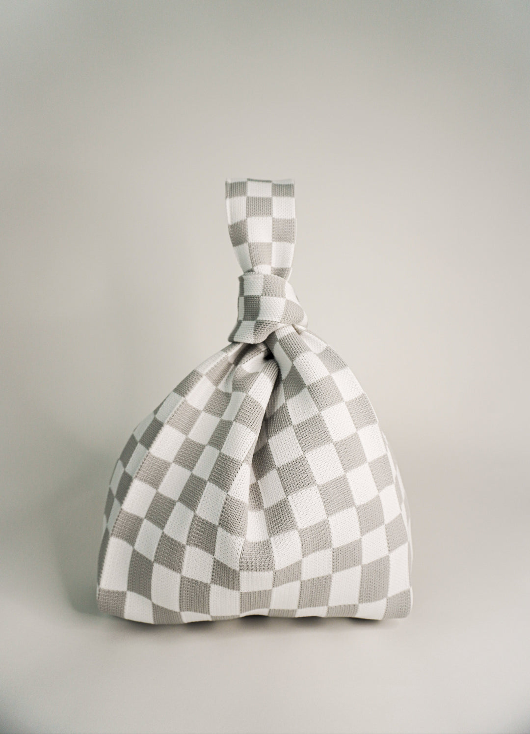 Classic checkered grey handbag with drawstring top and knot handle