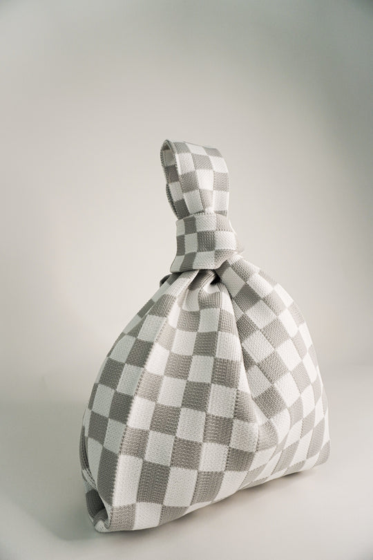 Grey-and-white checkered handbag with gathered fabric base and short drawcord