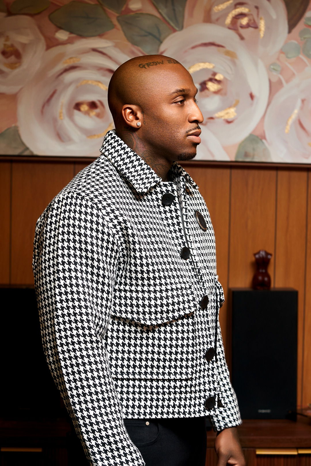 Close-up of houndstooth jacket collar and black buttons, boxy fit