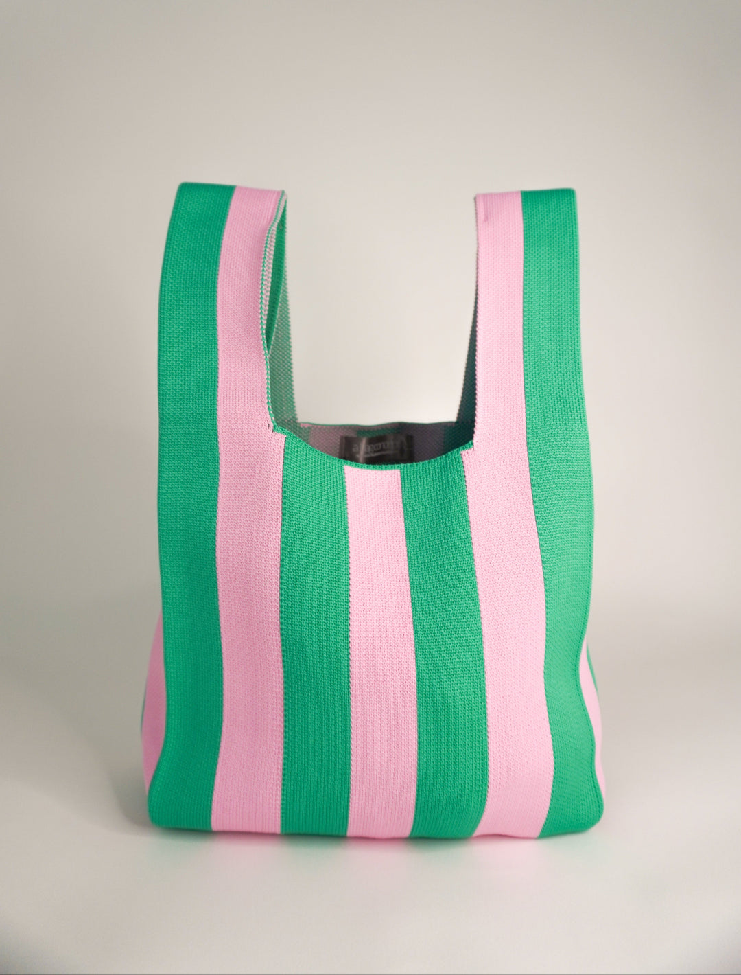 Open-top green and pink striped tote bag, with reinforced edges