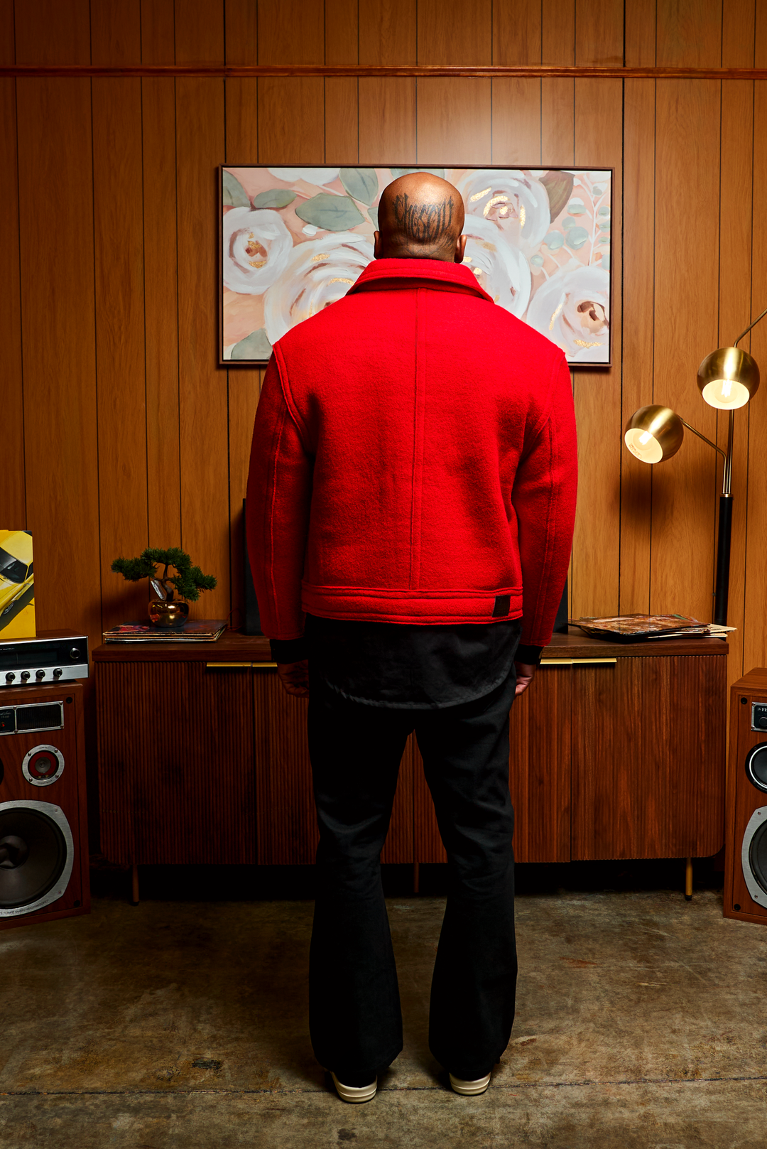 Red boxy jacket back view with centered seam and button cuffs
