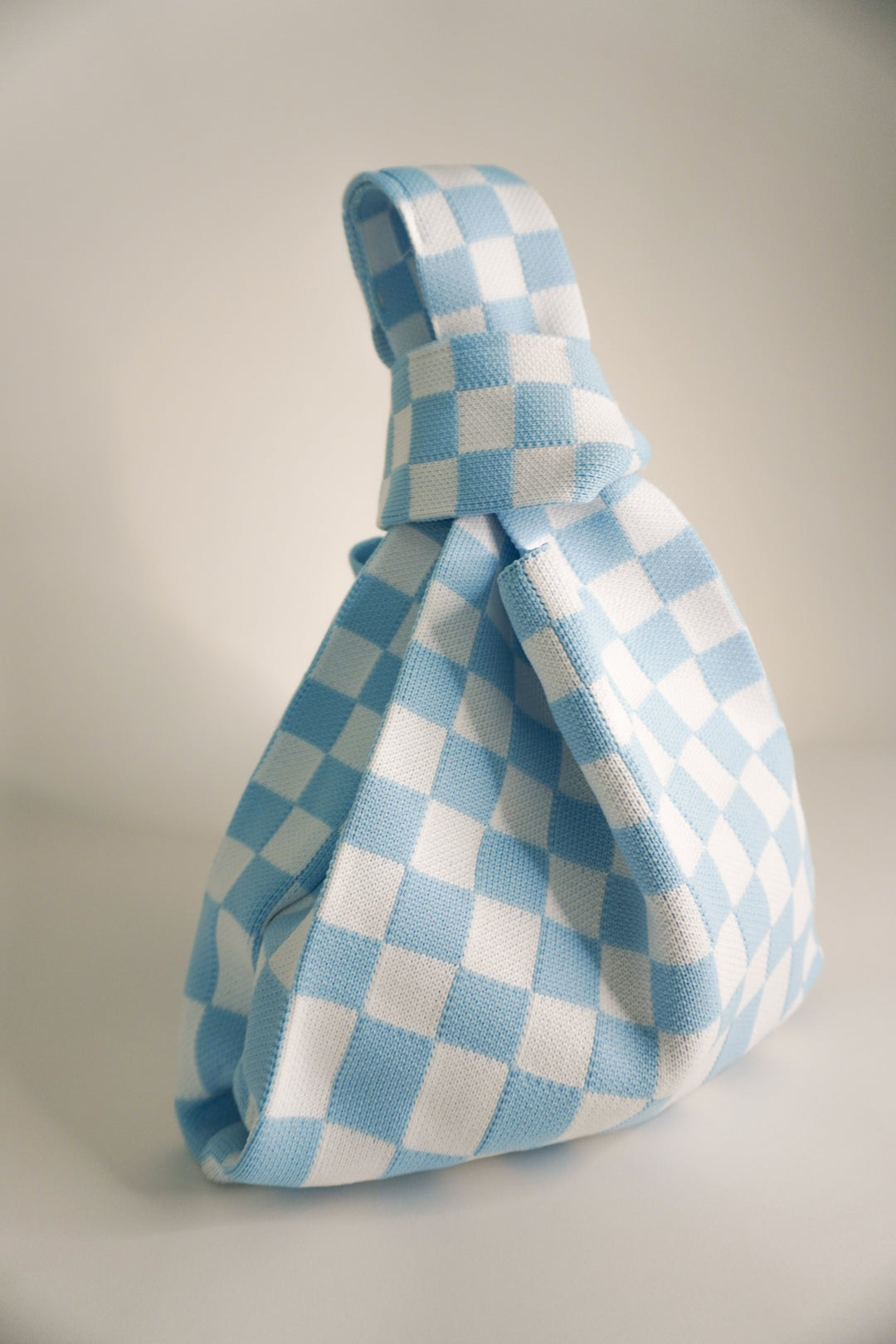 A Bag Concept classic checkered blue handbag, side profile with top handle
