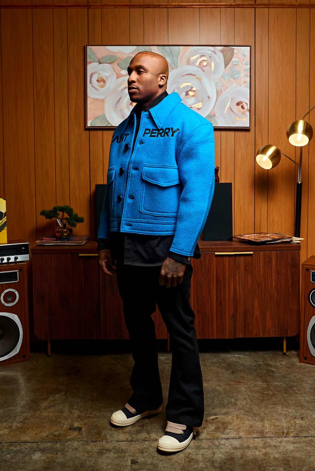 Blue boxy jacket side view: flap chest pockets, dark buttons, structured collar