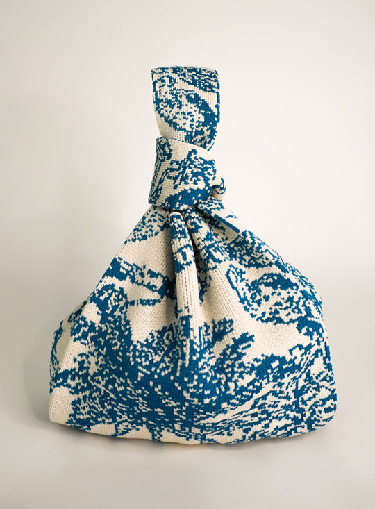 Palm Beach blue drawstring handbag in knit pattern, gathered top with tied cord.
