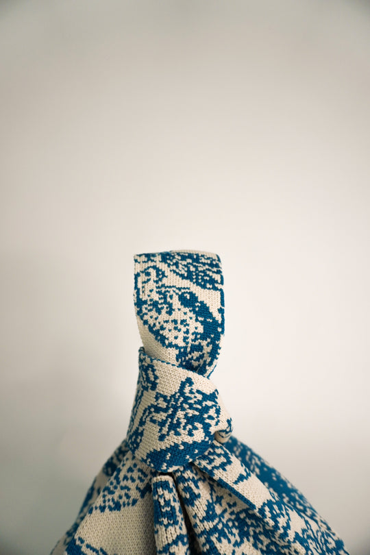Close-up of Palm Beach blue knit handle area with tied drawstring cord.