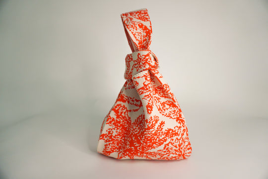 Palm Beach orange patterned drawstring pouch handbag, knot detail at top