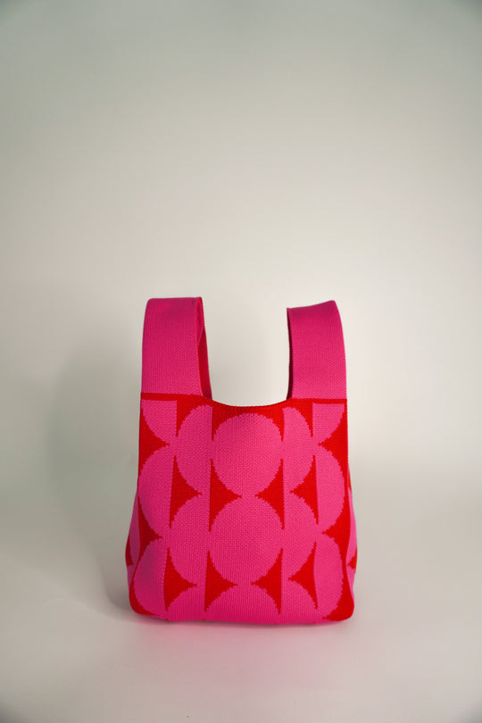 Pink Portobello handbag front view with floral leaf print and short handles