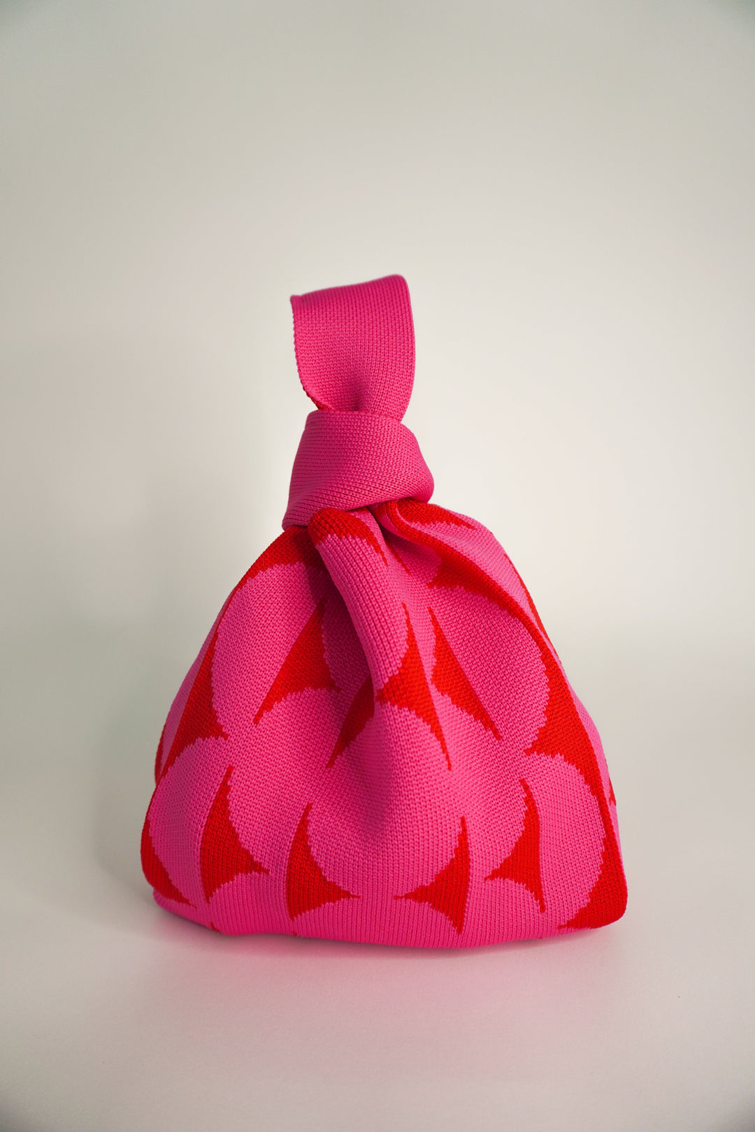 Pink Portobello drawstring handbag, front view with floral leaf print