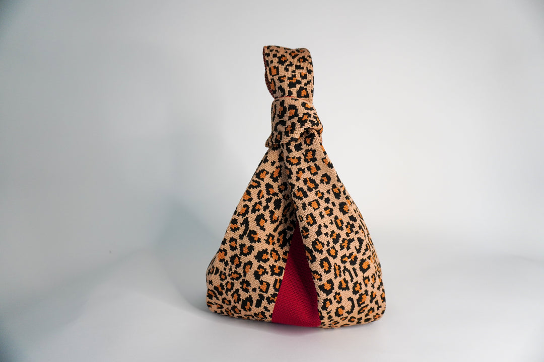 Leopard print handbag with red lining, gathered knotted top closure