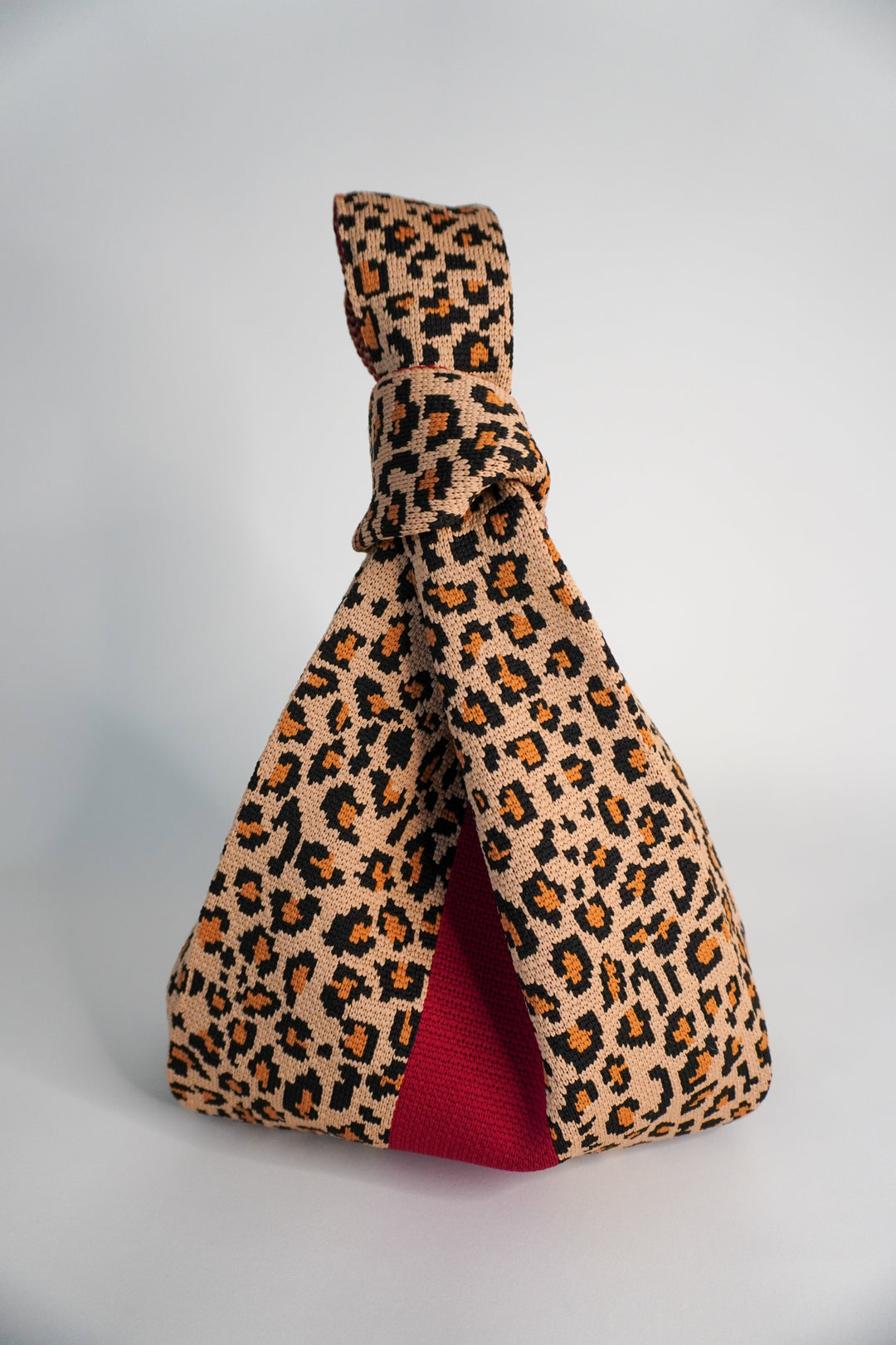 Wild One Handbag leopard print tote with red lining and knotted top handle