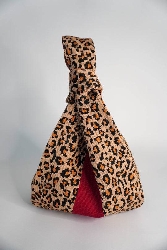 Wild One Handbag leopard print tote with red lining and knotted top handle