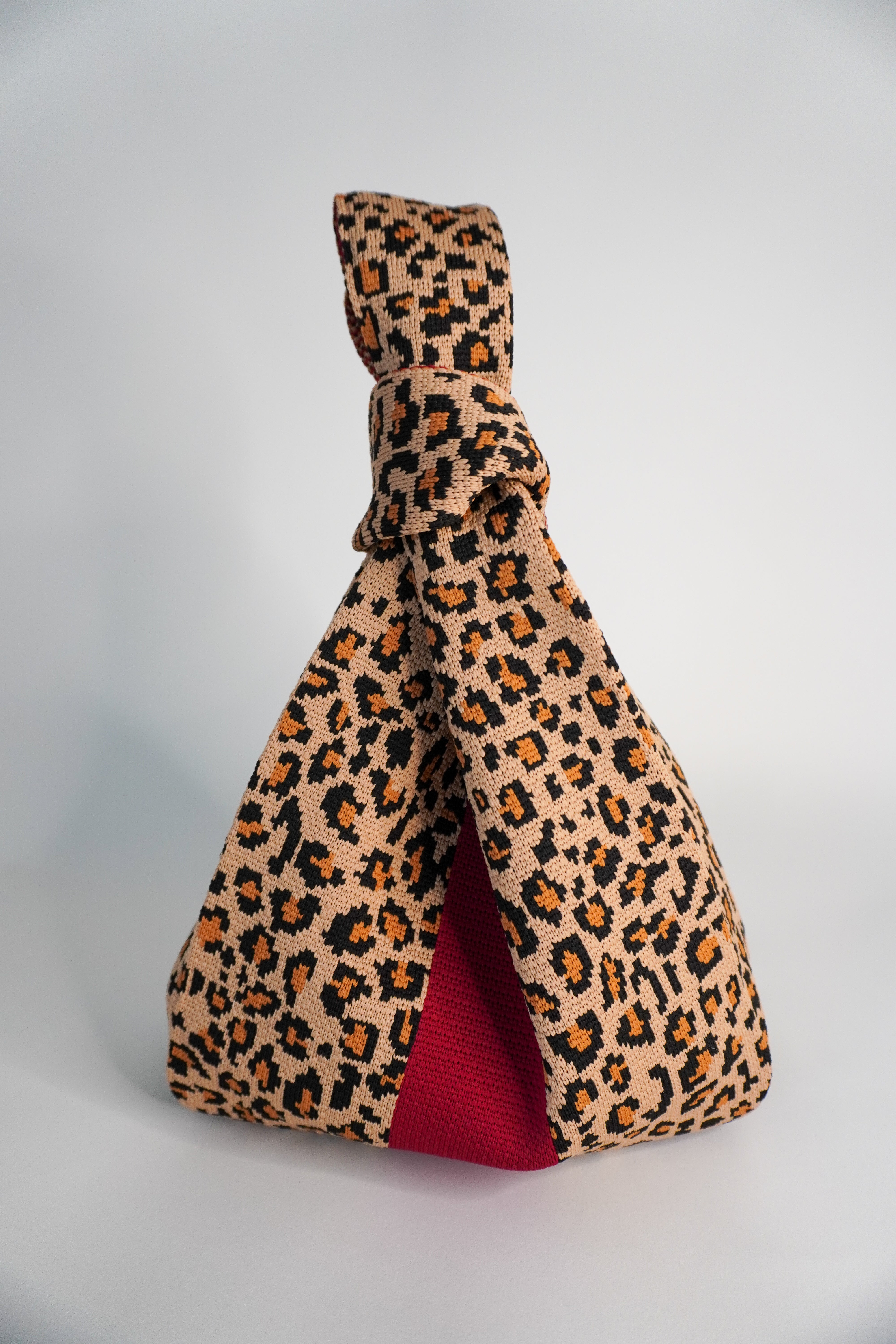 Wild One Handbag leopard print tote with red lining and knotted top handle