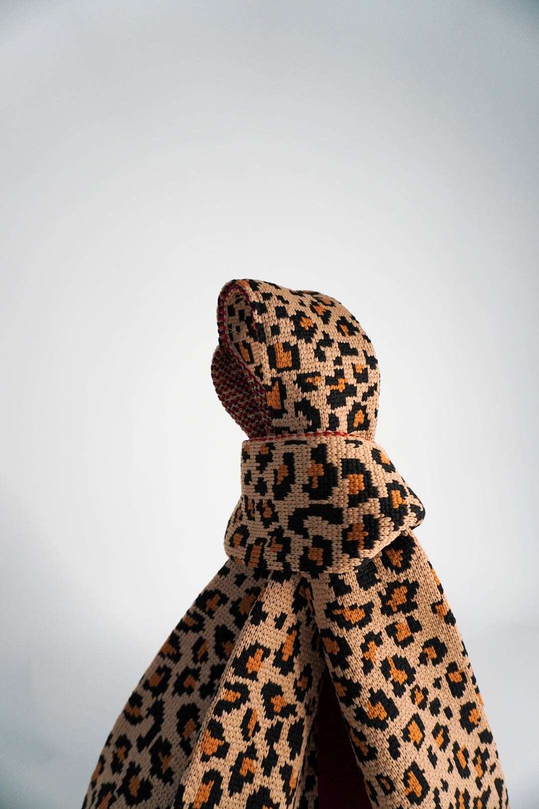 Leopard print mini tote handbag, close-up of knotted top and textured fabric