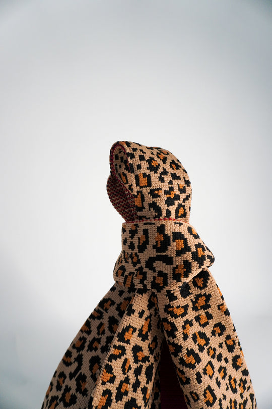 Leopard print mini tote handbag, close-up of knotted top and textured fabric