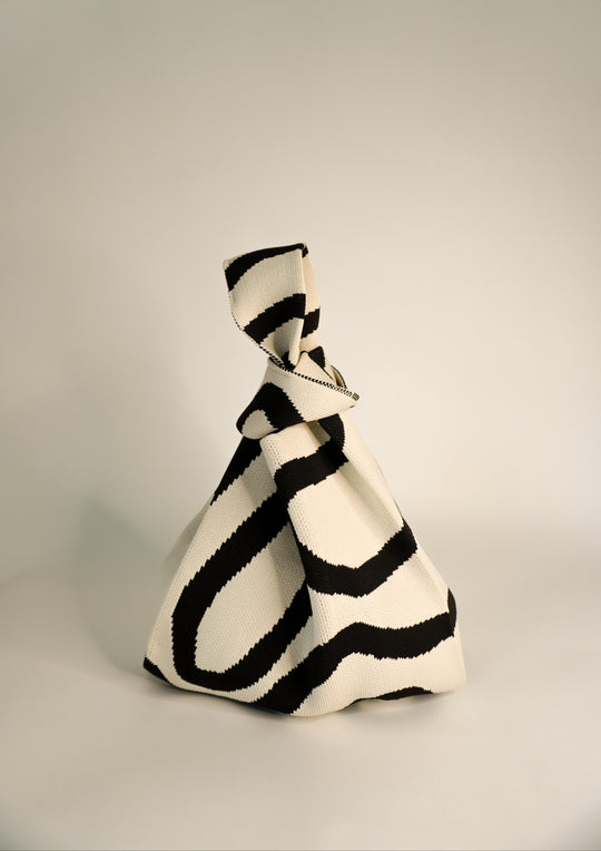Meander Black handbag with bold black-and-cream striped print and twisted handle