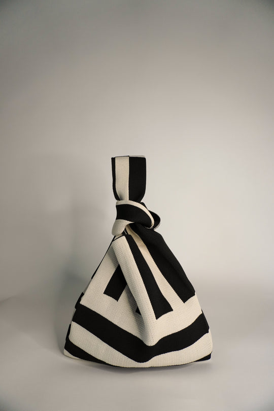 The Original² black-and-cream striped drawstring handbag, front view