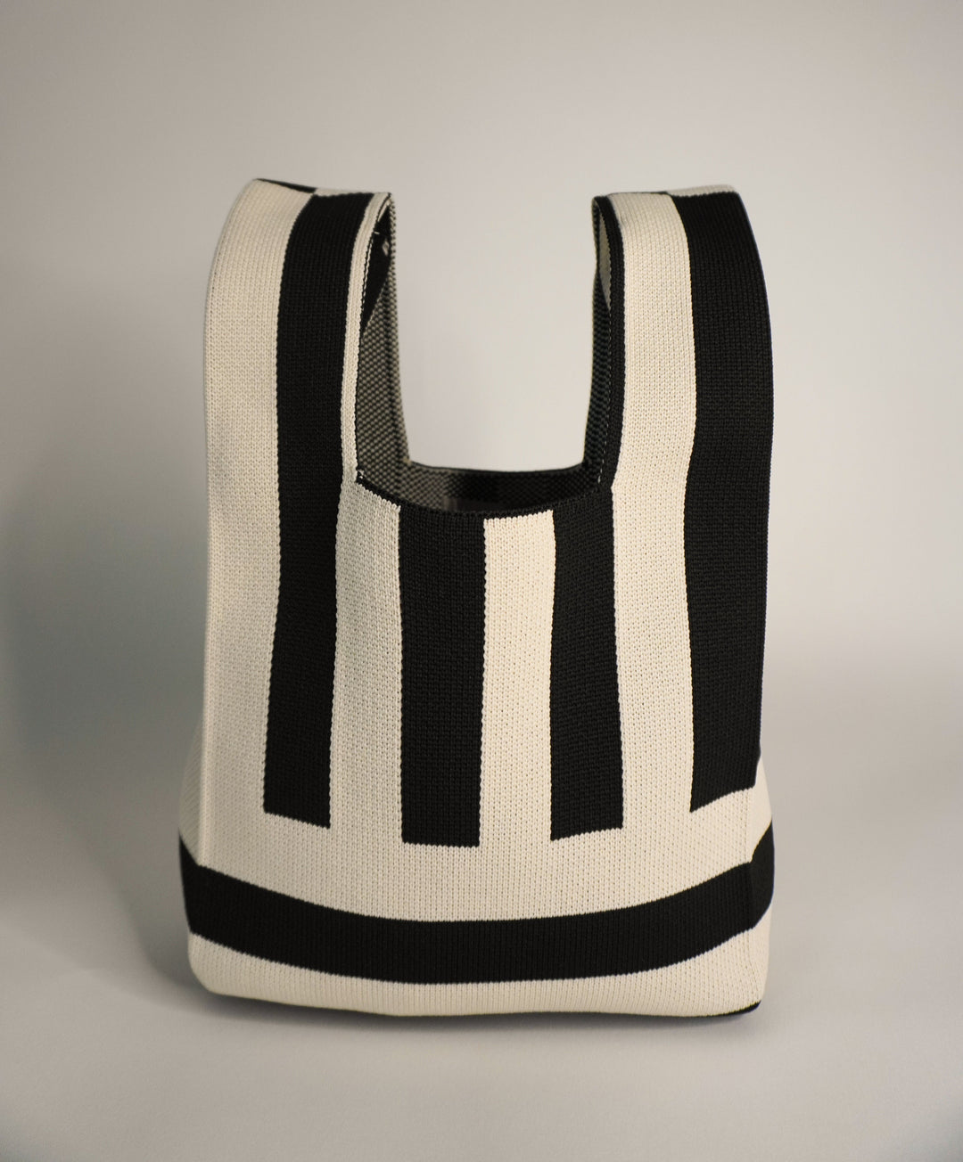 The Original² handbag with U-shaped handle opening and bold black-and-cream stripes
