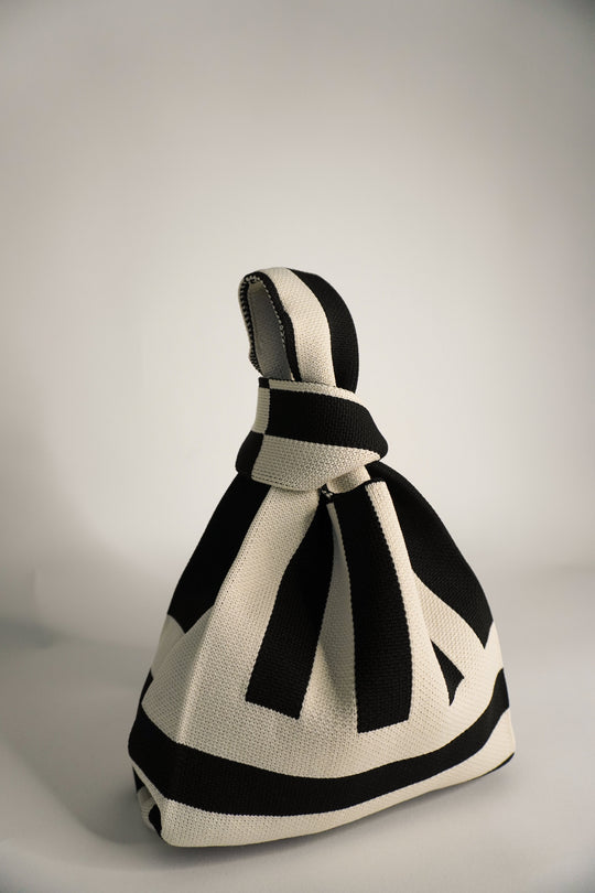 The Original² black and cream striped drawstring handbag with bow tie detail