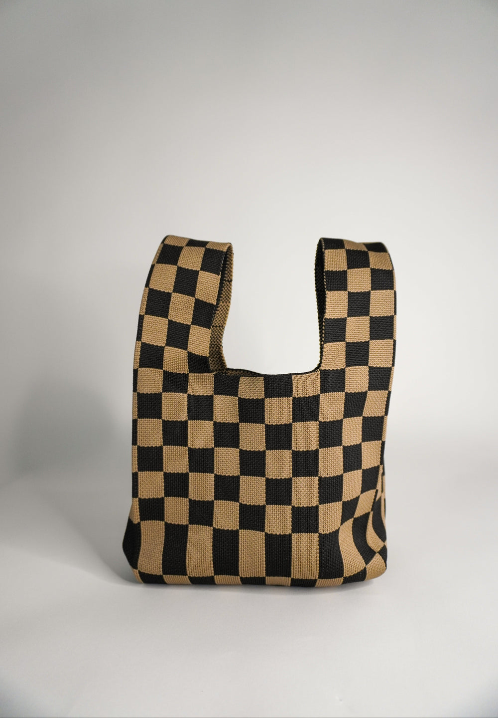 Checkered brown tote-style handbag with wide open front
