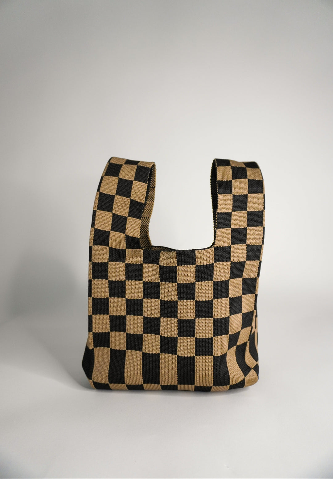 Checkered brown tote-style handbag with wide open front