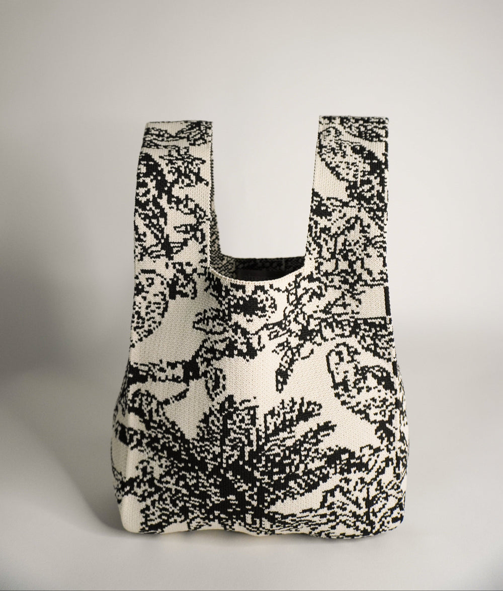 Palm Beach black handbag, front view with curved opening and black/white woven pattern