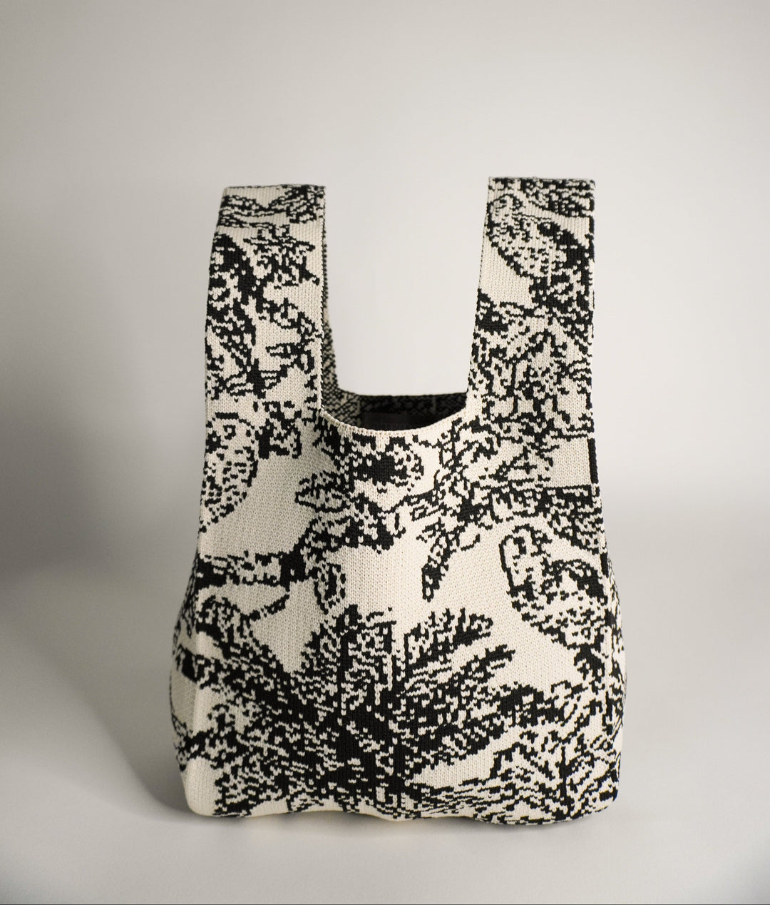 Palm Beach black handbag, front view with curved opening and black/white woven pattern