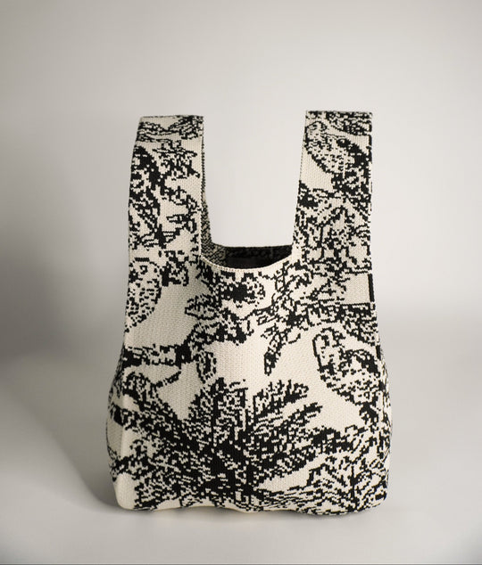 Palm Beach black handbag, front view with curved opening and black/white woven pattern