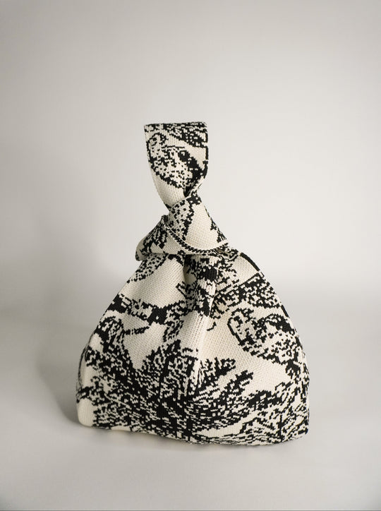 Palm Beach black handbag in monochrome woven pattern, tied drawstring top