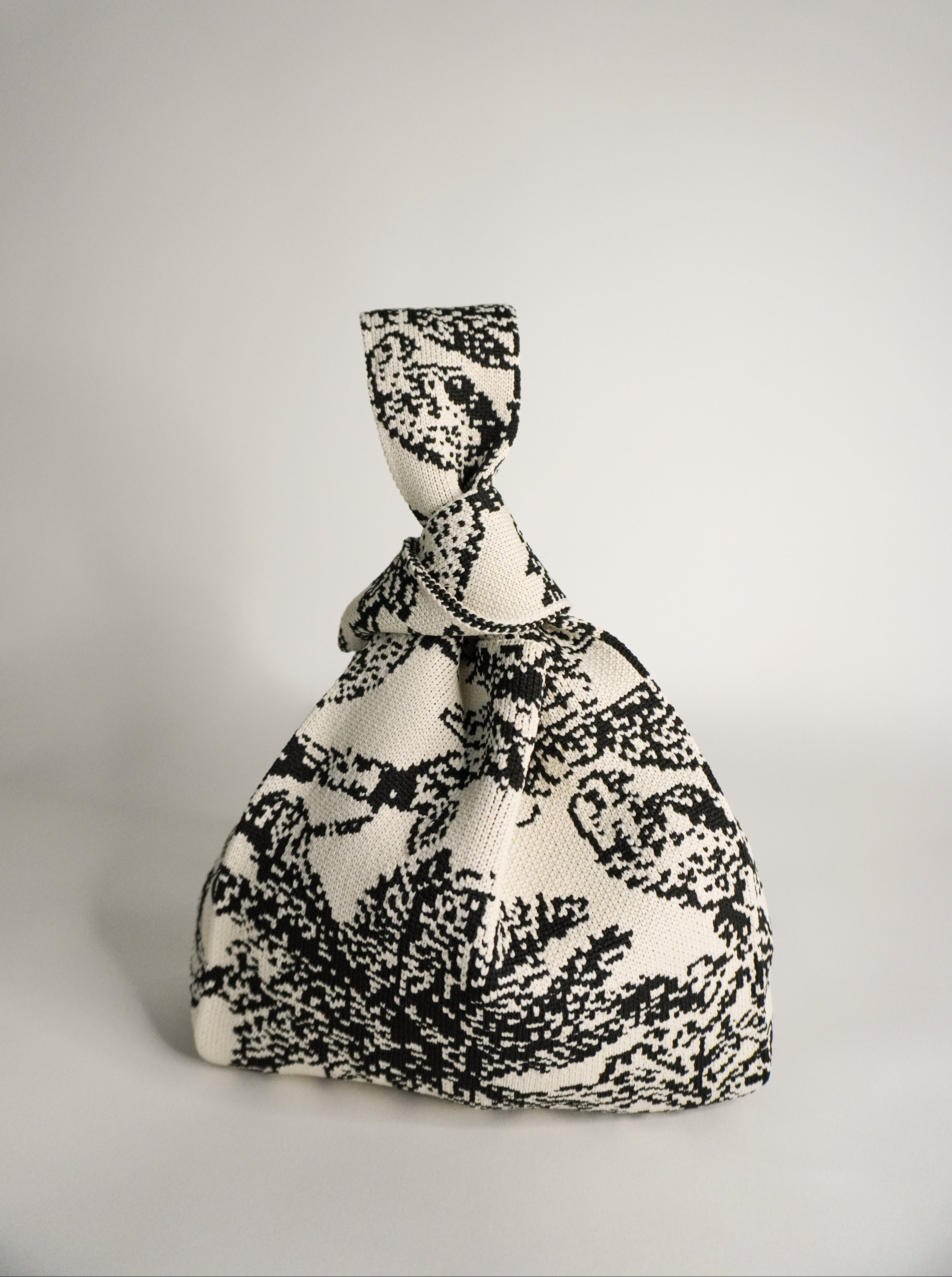 Palm Beach black handbag in monochrome woven pattern, tied drawstring top
