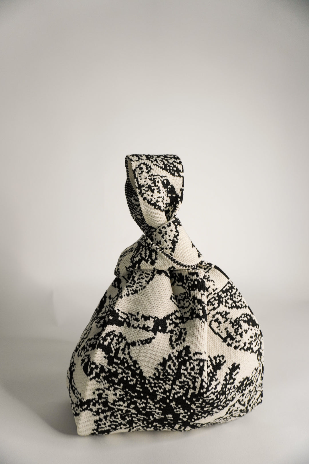 Palm Beach black handbag with knotted handle and gathered fabric, monochrome print
